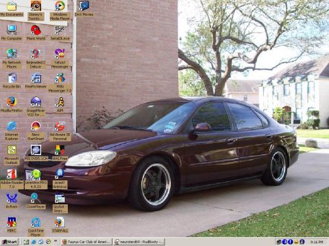 1993 Ford Taurus - A desktop computer screen displays a car as wallpaper, overlaid with program icons and a taskbar.