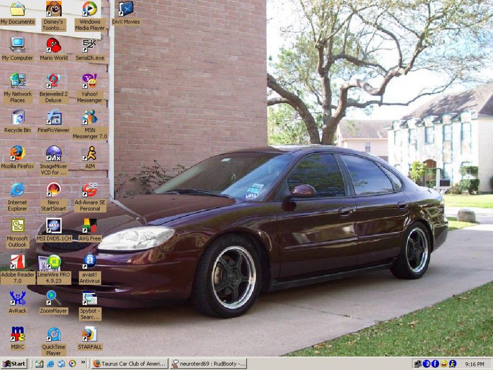 Desktop computer screen showing a dark red sedan as wallpaper, with various program icons on the left