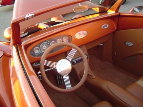 1979 Ford Bronco - Interior view of a custom orange hot rod, tan upholstery and a vintage-style dashboard.