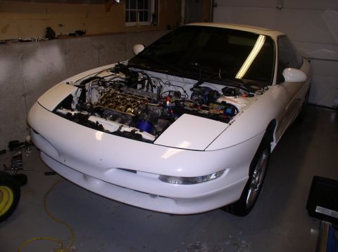 1996 Ford Probe - White coupe with hood open, revealing engine parts. The front bumper shows damage.