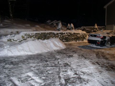1996 Ford Probe - Car covered in snow, parked in a driveway during winter at night.