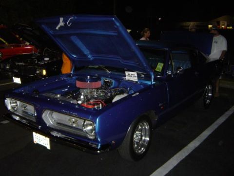 1979 Ford Bronco - A blue 1967 Plymouth Barracuda is displayed with its hood open, revealing the engine bay and interior.
