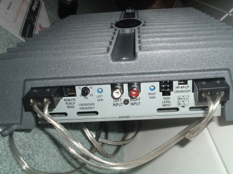1994 Ford Probe - Rear view of a car amplifier showing various input and control connections, including RCA inputs and speaker terminals.