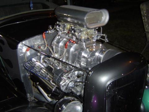 1979 Ford Bronco - Custom V8 engine with blower and flame graphics on fender. Supermotors.net logo is present.