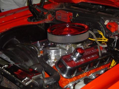 1979 Ford Bronco - Close-up view of a modified engine bay with custom chrome and red accents.