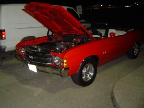 1979 Ford Bronco - A red convertible with SS badging is parked with its hood open, revealing the engine compartment.