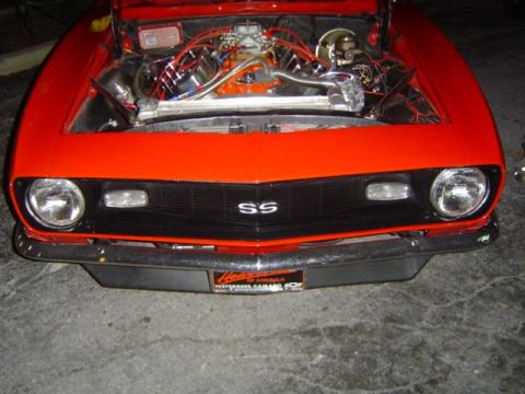 1979 Ford Bronco - 1969 Chevrolet Camaro SS front end with hood open, revealing the engine compartment.