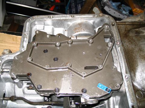 1984 Ford Bronco - The internal components of an automatic transmission are visible after removing the pan and valve body cover.