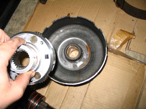 1984 Ford Bronco - Close-up of a transmission component being handled, with another part visible.