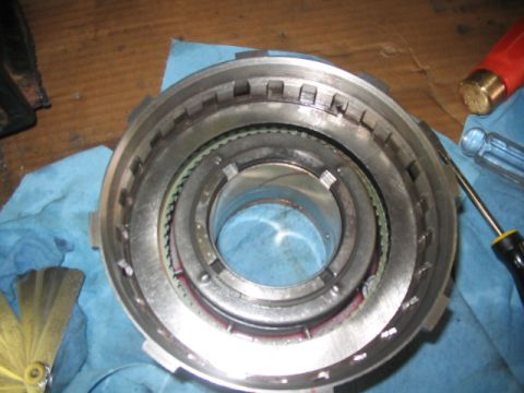 1984 Ford Bronco - Automatic transmission clutch pack assembly shown with tools, likely for repair or inspection.