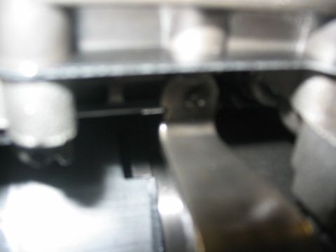 1984 Ford Bronco - Detail of a transmission component, likely a lever or linkage, inside a housing.