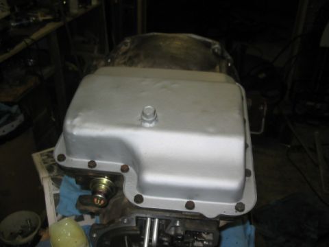 1984 Ford Bronco - A silver transmission pan is shown, likely part of a larger vehicle component.