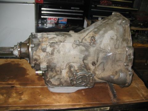 1984 Ford Bronco - Automatic transmission, possibly from a Mercedes-Benz, resting on a wooden surface.