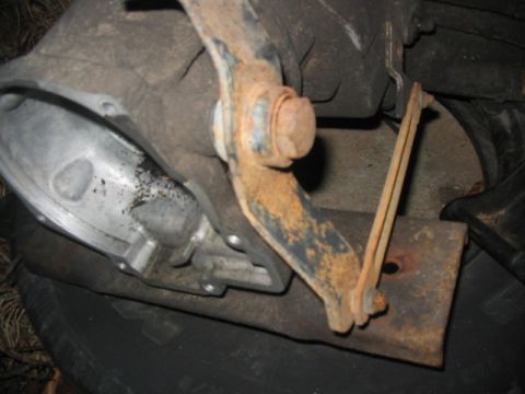 1984 Ford Bronco - Close-up of a corroded transmission linkage mechanism.