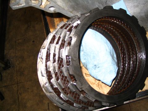 1984 Ford Bronco - A stack of transmission clutch plates, showing wear and oil saturation.