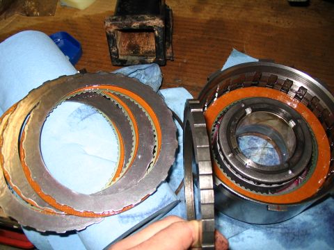 1984 Ford Bronco - Disassembled transmission clutch pack and drum components laid out on blue shop towels.