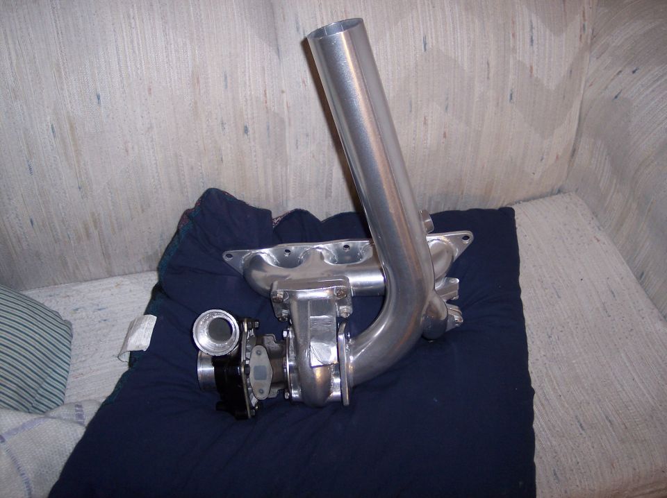 Turbo manifold with turbocharger and large downpipe on a blue pillow