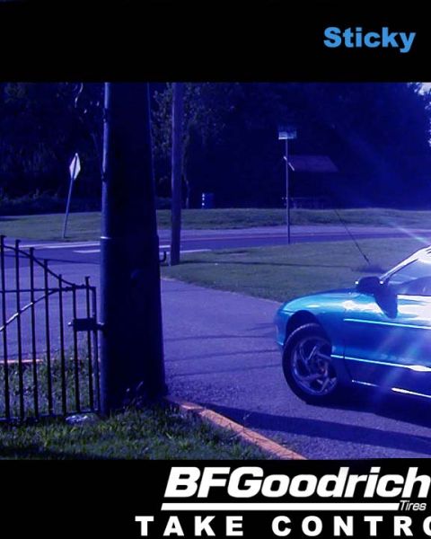 1994 Ford Probe - A teal coupe is seen from the front-right, parked near a fence and a street light.