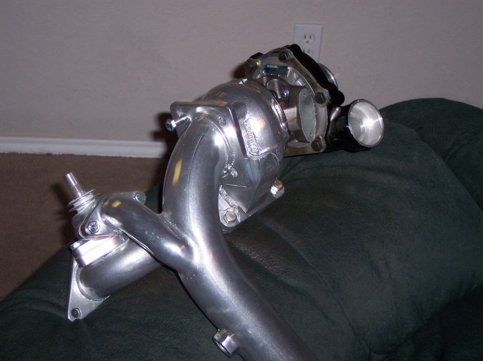 Turbocharger with manifold, wastegate and blow-off valve on a green couch