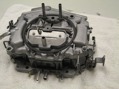 1991 Ford LTD Crown Victoria - Carter cast-aluminum four-barrel carburetor shown from the front on a white towel, showing the air horn and fuel inlets.