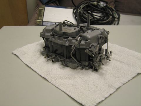 1991 Ford LTD Crown Victoria - four-barrel carburetor sits on a white towel, photographed from above with coiled wires behind it.