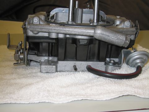 1991 Ford LTD Crown Victoria - Side view of a carburetor on a white towel showing a vacuum diaphragm, hose and a cast number reading 6411S.