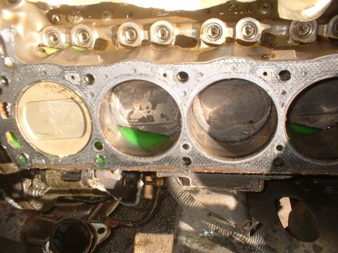 1993 Ford Bronco - The internal components of an engine are shown, with some cylinders containing green fluid.
