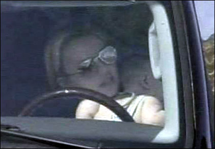 1991 Ford Bronco - A person is seen through the windshield, wearing glasses and sitting behind the steering wheel.