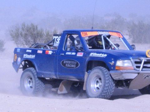 Blue Byrd Racing Ford race truck 736 racing through dusty desert brush