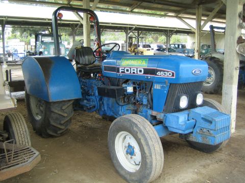 1968 Ford Mustang - A blue Ford 4630 tractor is parked under a covered structure.