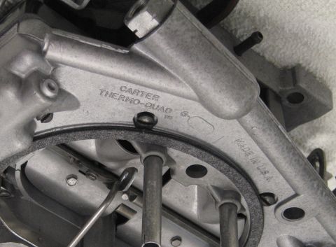 1991 Ford LTD Crown Victoria - Detailed close-up of a carburetor casting bearing the cast words Carter Thermo-Quad and Made in USA.