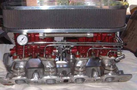 1972 Ford Ranchero - Close-up of a dual carburetor intake manifold assembly with an air filter and gauge.