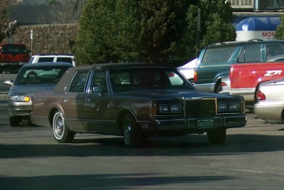 1972 Ford Ranchero - A brown sedan with wood paneling is parked in a lot with other vehicles.