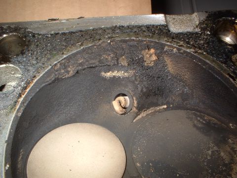 1993 Ford Bronco - This image shows the interior of an engine cylinder head, heavily coated in carbon deposits and grime.