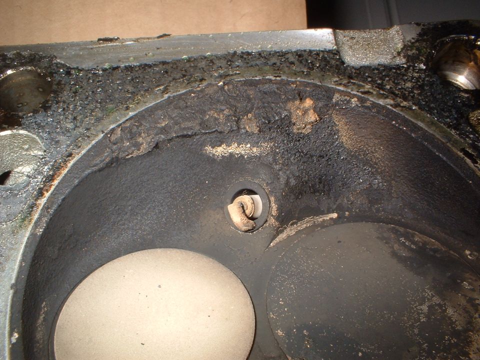 Carbon-caked combustion chamber of a cast iron cylinder head with cleaned valve faces