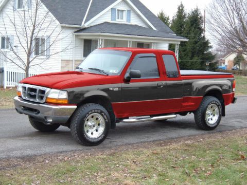 1997 Ford Probe - A two-tone Ford Ranger pickup truck is parked on a residential street in front of a house.