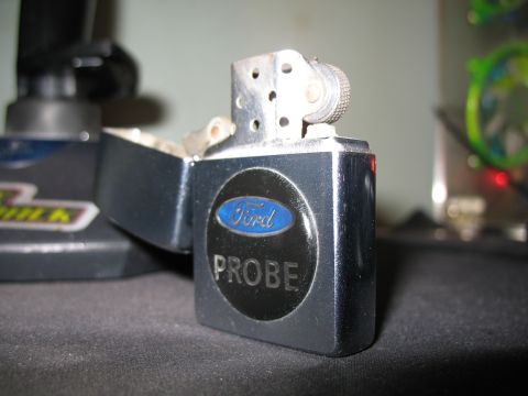 1996 Ford Probe - A Zippo lighter features a Ford Probe emblem, not a vehicle.