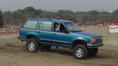 1984 Ford Bronco - This teal Ford Explorer is equipped with a lifted suspension and appears to be off-roading.