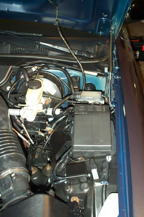 1998 Ford Crown Victoria - Complete. The adapter blends in well with the engine bay and the wire looms and electrical tape conceal the additional wiring.