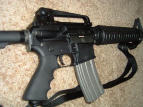 1992 Ford Probe - A close-up view of an assault rifle, showing its grip and magazine.