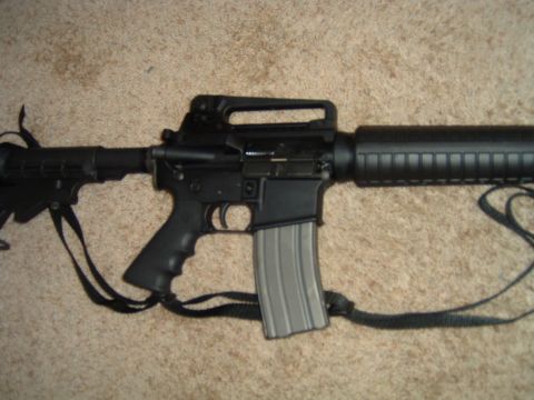 1992 Ford Probe - An AR-15 style rifle is shown lying on a carpeted surface.