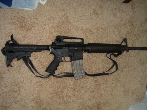 1992 Ford Probe - AR-15 style rifle with a sling is shown on a carpeted surface.