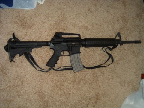 1992 Ford Probe - An assault rifle is pictured on a carpeted surface, with a visible watermark at the bottom right.
