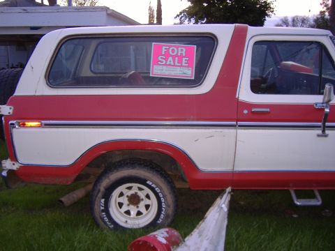 1978 Ford Bronco - This two-tone red and white 1978 Ford Bronco is parked outdoors with a "FOR SALE" sign visible in the rear window.