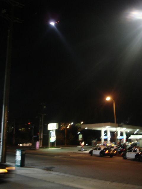 1993 Ford Taurus - Police vehicles are visible at a gas station during nighttime hours.
