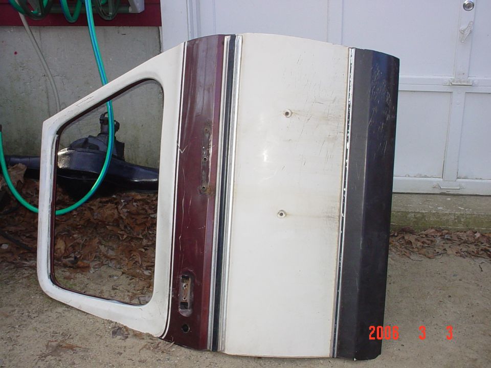 White car door with maroon stripe and chrome trim, detached