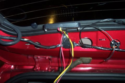 2005 Ford Explorer - Close-up of a vehicle's interior wiring harness, showing red paint and various electrical connections.