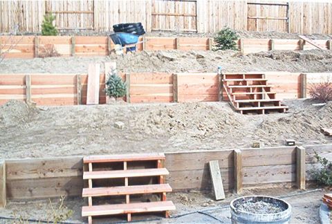 1986 Ford Bronco - A backyard construction project is underway, tiered wooden retaining walls and newly built wooden stairs.