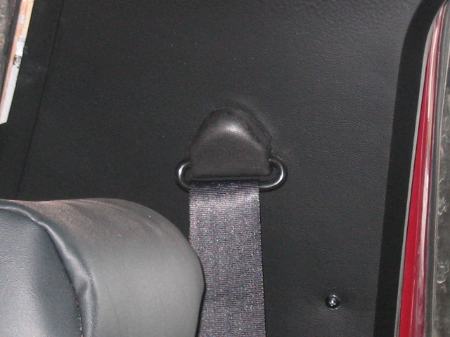 Seatbelt anchor point on black interior panel