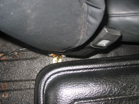 1991 Ford Bronco - Seatbelt buckle and mounting hardware visible in the interior of a vehicle.